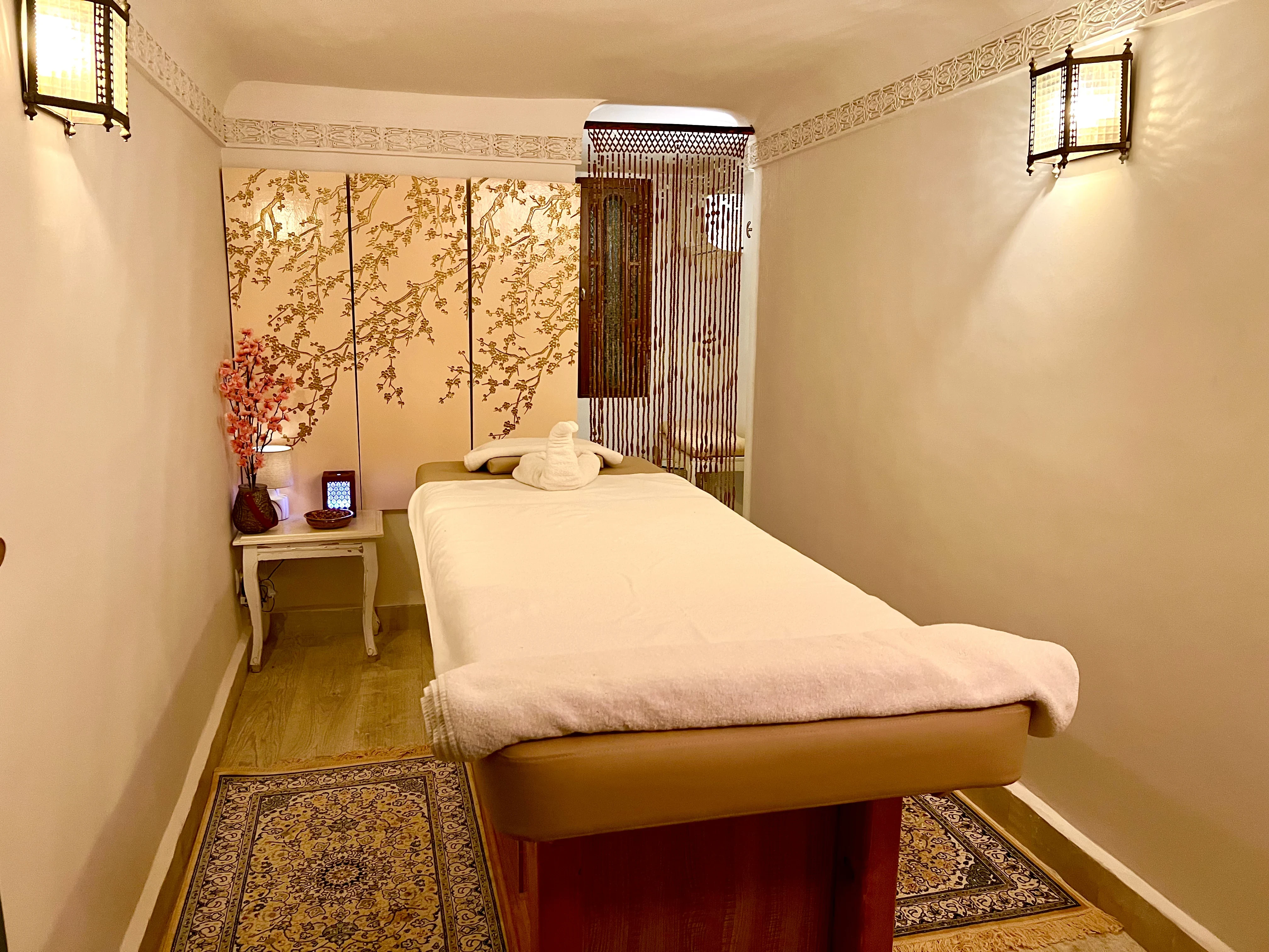 Relaxing massage treatment room with professional table at Spa du Calife - Riad Le Calife Fes